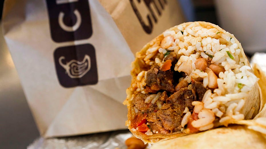 FILE - A steak burrito is arranged for a photograph with a drink and bags of chips at a Chipotle Mexican Grill Inc. restaurant in Hollywood, California, on July 16, 2013. Photographer: Patrick T. Fallon/Bloomberg via Getty Images