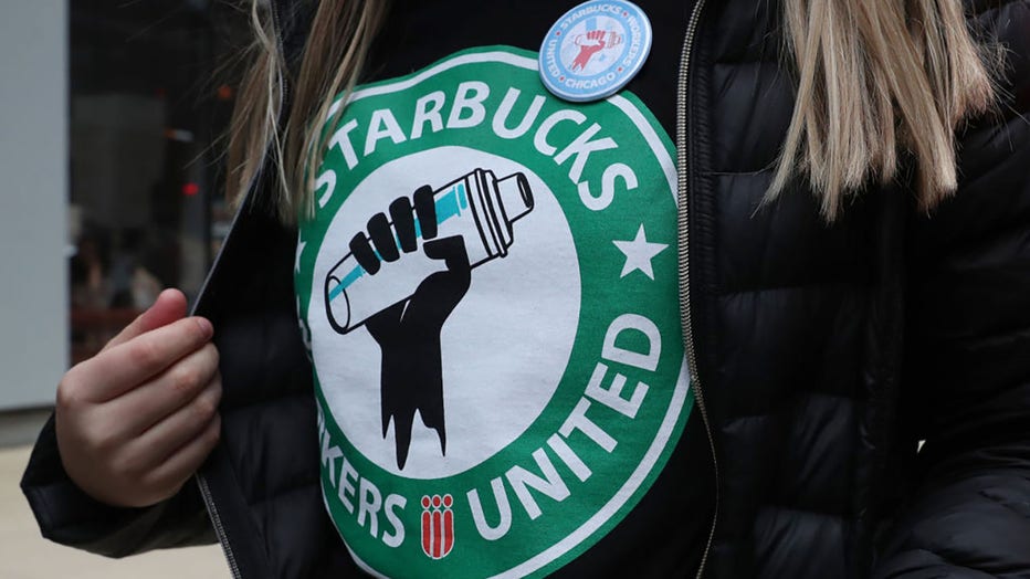 FILE - A Starbucks worker wears a t-shirt and button promoting unionization on April 7, 2022, in Chicago. (John J. Kim/Chicago Tribune/Tribune News Service via Getty Images)