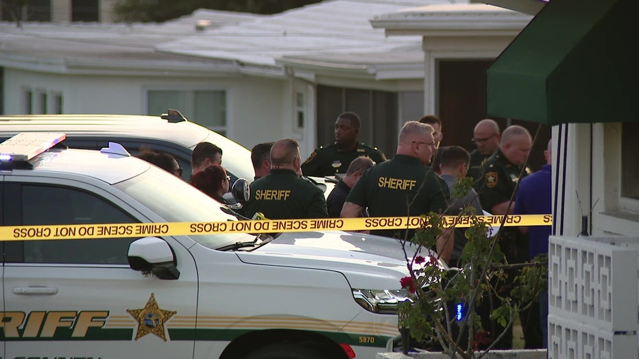 Law enforcement officers gather at scene of deputy-involved shooting. 