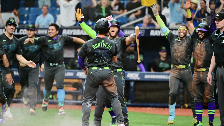 ST PETERSBURG, FLORIDA - MAY 05: Harold Ramirez #43 of the Tampa Bay Rays reacts as Ben Rortvedt #30 crosses the plate to score to defeat the New York Mets 7-6 in the 10th inning at Tropicana Field on May 05, 2024 in St Petersburg, Florida. (Photo by Julio Aguilar/Getty Images)