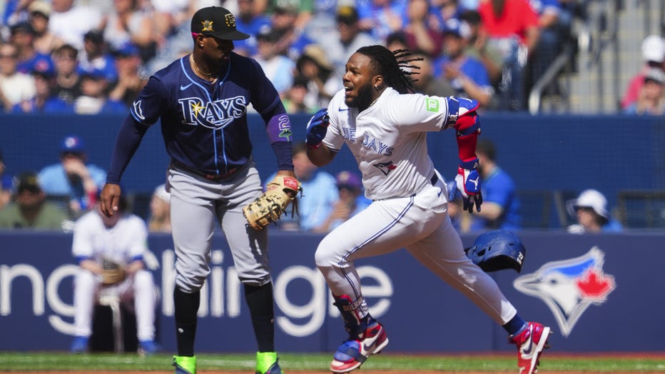 TORONTO, ON - MAY 18: Vladimir Guerrero Jr. #27 of the Toronto Blue Jays runs the bases on his double against the Tampa Bay Rays during the fourth inning in their MLB game at the Rogers Centre on May 18, 2024 in Toronto, Ontario, Canada. (Photo by Mark Blinch/Getty Images)