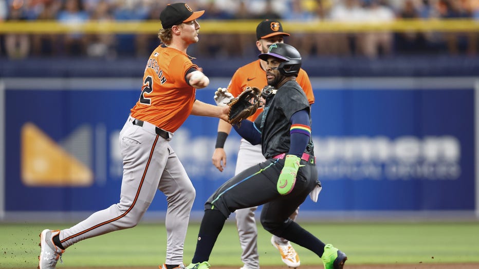 ST PETERSBURG, FLORIDA - JUNE 08: Gunnar Henderson #2 of the Baltimore Orioles fields a ball as Yandy Díaz #2 of the Tampa Bay Rays looks on during the first inning at Tropicana Field on June 08, 2024 in St Petersburg, Florida. (Photo by Douglas P. DeFelice/Getty Images)