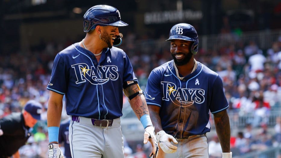 ATLANTA, GEORGIA - JUNE 16: Jose Siri #22 of the Tampa Bay Rays reacts with Randy Arozarena #56 after hitting a two run home run during the ninth inning against the Atlanta Braves at Truist Park on June 16, 2024 in Atlanta, Georgia. (Photo by Todd Kirkland/Getty Images)