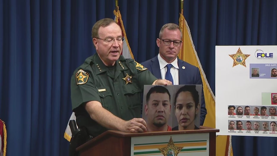 Polk County Sheriff Grady Judd holds up images of Pilar Rivera and Hector Baez Torres. 