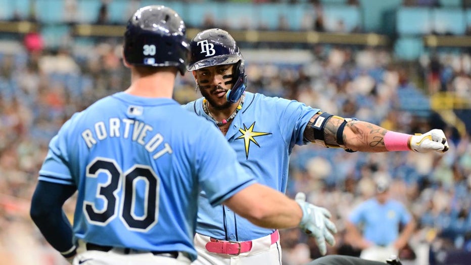 ST PETERSBURG, FLORIDA - JULY 14: Jose Siri #22 of the Tampa Bay Rays celebrates with Ben Rortvedt #30 after hitting a home run in third inning against the Cleveland Guardians at Tropicana Field on July 14, 2024 in St Petersburg, Florida. (Photo by Julio Aguilar/Getty Images)