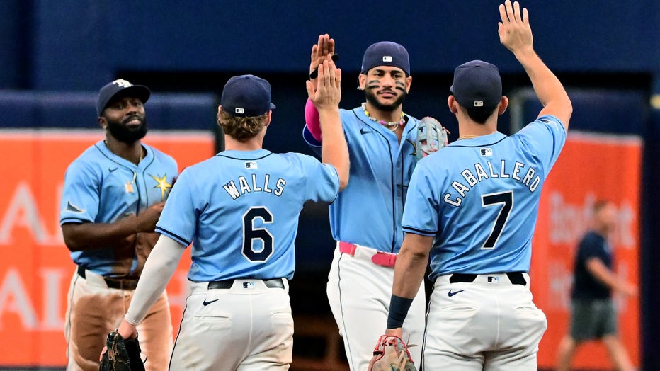 ST PETERSBURG, FLORIDA - JULY 14: Jose Siri #22 and Randy Arozarena #56 of the Tampa Bay Rays celebrates with Taylor Walls #6 and José Caballero #7 after defeating the Cleveland Guardians 2-0 at Tropicana Field on July 14, 2024 in St Petersburg, Florida. (Photo by Julio Aguilar/Getty Images)