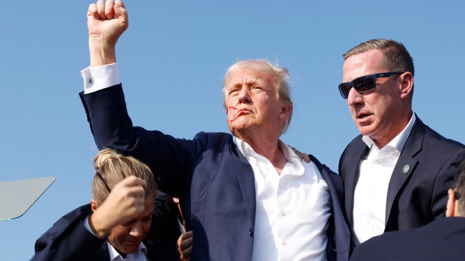 BUTLER, PENNSYLVANIA - JULY 13: Republican presidential candidate former President Donald Trump is rushed offstage during a rally on July 13, 2024 in Butler, Pennsylvania. Butler County district attorney Richard Goldinger said the shooter is dead after injuring former U.S. President Donald Trump, killing one audience member and injuring another in the shooting. (Photo by Anna Moneymaker/Getty Images)