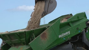 Machines sifting debris from sand left behind after Hurricanes Helene, Milton