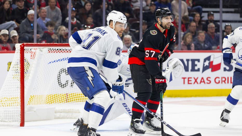 OTTAWA, ON - OCTOBER 19: Tampa Bay Lightning Defenceman Erik Cernak (81) battles Ottawa Senators Left Wing David Perron (57) during third period National Hockey League action between the Tampa Bay Lightning and Ottawa Senators on October 19, 2024, at Canadian Tire Centre in Ottawa, ON, Canada. (Photo by Richard A. Whittaker/Icon Sportswire via Getty Images)