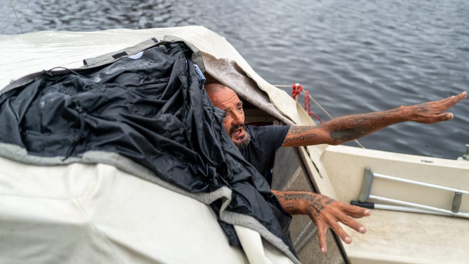 TAMPA, FLORIDA - OCTOBER 09: Tampa police try to persuade a local resident who is living on his boat known as Jay and nicknamed 