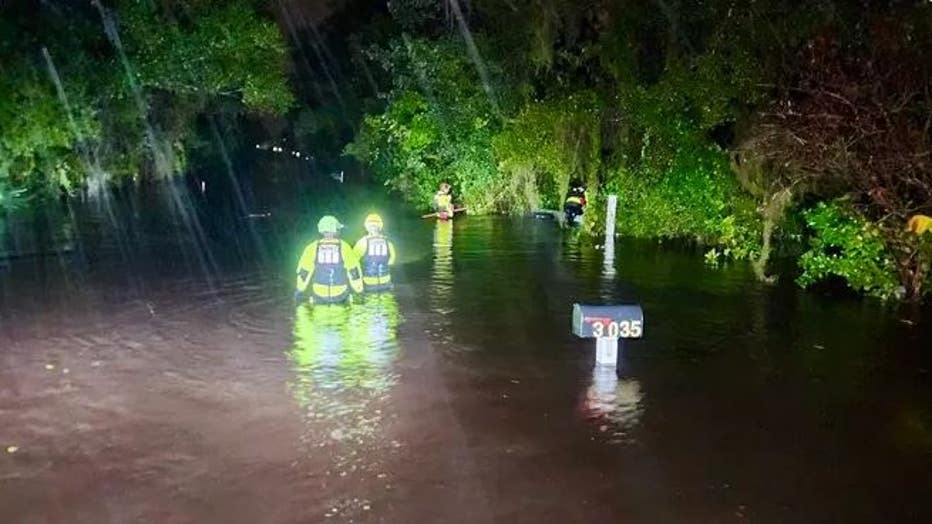 The Orange County Sheriff's Office waded through chest-deep water to checking on homes in a flooded Orlando neighborhood on Thursday morning, Oct. 10, 2024. (@OrangeCoSheriff / X)