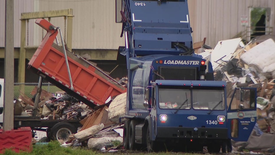 Debris from Hurricane Helene being unloaded at a landfill before Hurricane Milton makes landfall.