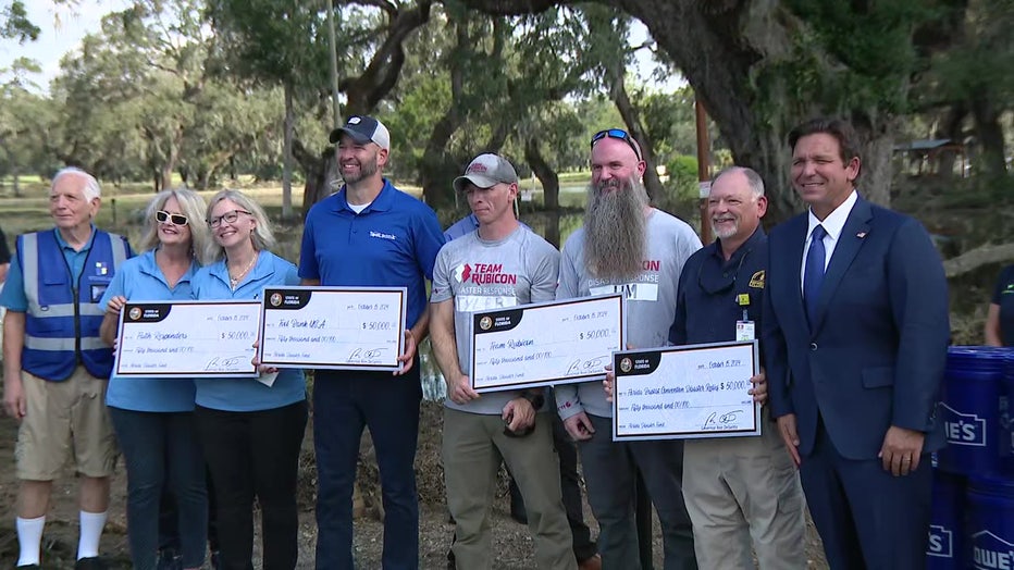 Governor Ron DeSantis awarding financial aid to Pasco County Officials and companies aiding in Hurricane Milton recovery efforts.