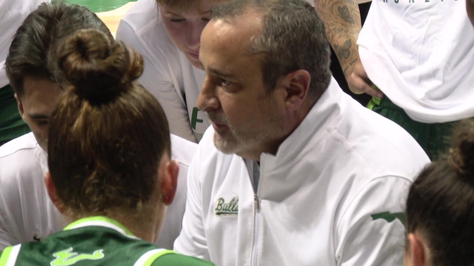 USF women's head basketball coach Jose Fernandez coaching the team.