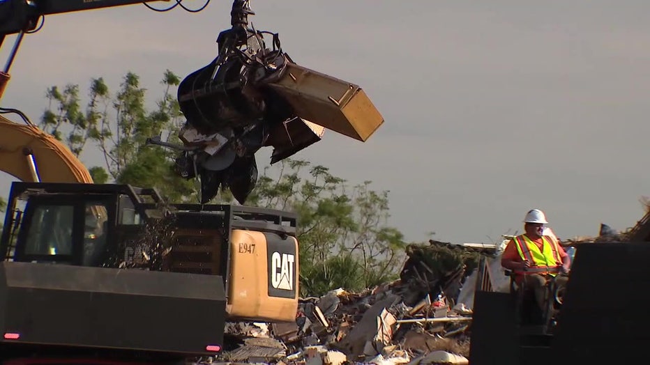 Crews work to remove hurricane debris.