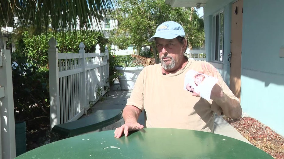 Bruce Dworsky holds the retrieved picture of his granddaughter.