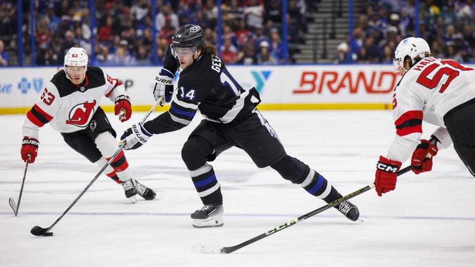 TAMPA, FL - NOVEMBER 16: Conor Geekie #14 of the Tampa Bay Lightning skates against Jesper Bratt #63 of the New Jersey Devils during the first period at Amalie Arena on November 16, 2024 in Tampa, Florida. (Photo by Mark LoMoglio/NHLI via Getty Images)