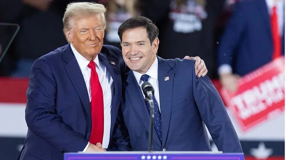 Former President and Republican presidential nominee Donald Trump greets GOP Sen. Marco Rubio, Republican of Florida, during a campaign rally at the J.S. Dorton Arena in Raleigh, North Carolina, on November 4, 2024. (Getty Images)