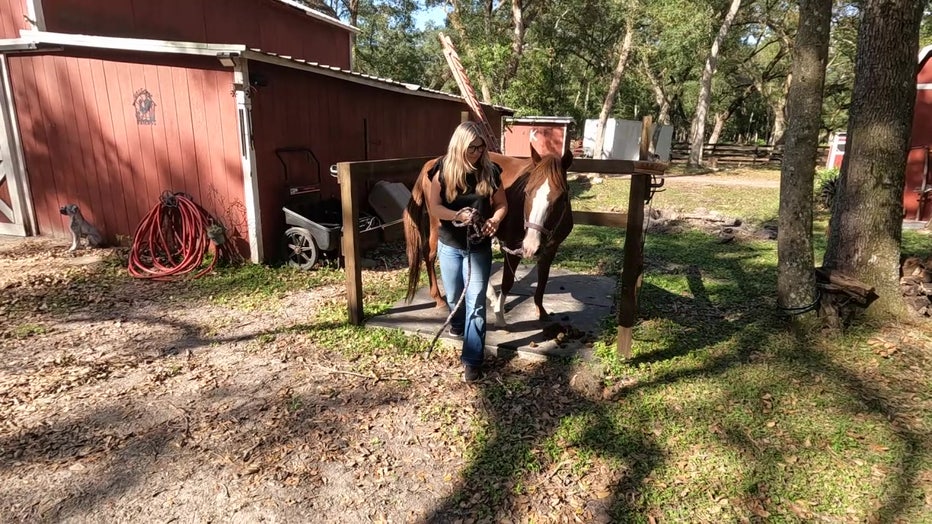 Averie Kimelton with the horse she saved after Hurricane Milton.