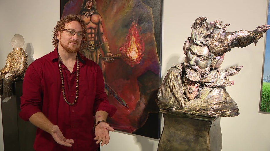 Artist Blake Emory stands in front of his painting Conan the Barbarian, on display at the Imagine Museum.