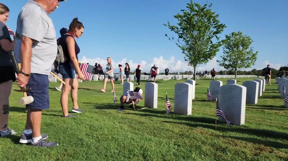 Families placing wreathes on the graves of veterans at Sarasota National Cemetery.