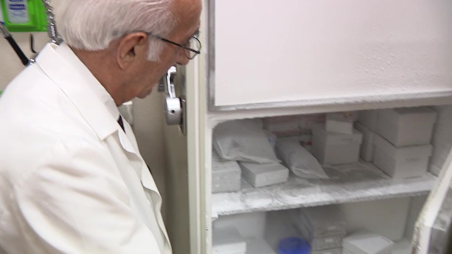 Dr. Cameron Tebbi showing materials used in testing potential vaccines for pediatric leukemia vaccines.