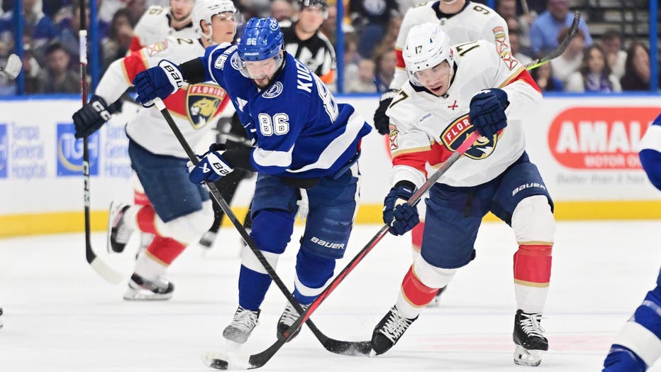 TAMPA, FLORIDA - DECEMBER 22: Evan Rodrigues #17 of the Florida Panthers controls the puck against Nikita Kucherov #86 of the Tampa Bay Lightning in the first period of a game at Amalie Arena on December 22, 2024 in Tampa, Florida. (Photo by Julio Aguilar/Getty Images)