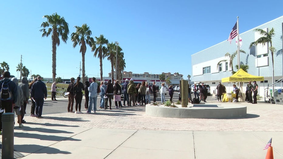 Hospitality workers wait on line for gift cards from the Tampa Bay Beaches Chamber of Commerce.