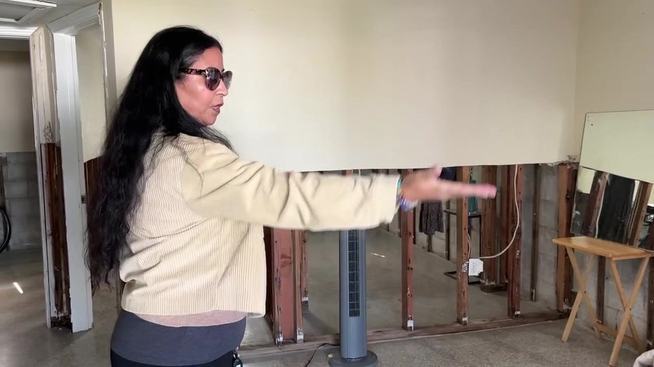 Yarisi Valero showing damage to her Madeira Beach home caused by Hurricane Helene.