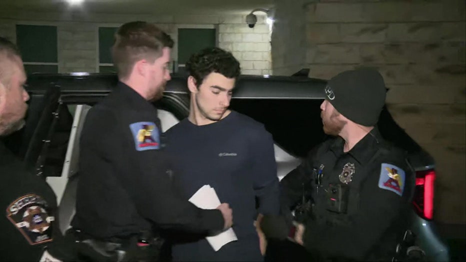Mangione being apprehended by NYPD officers.