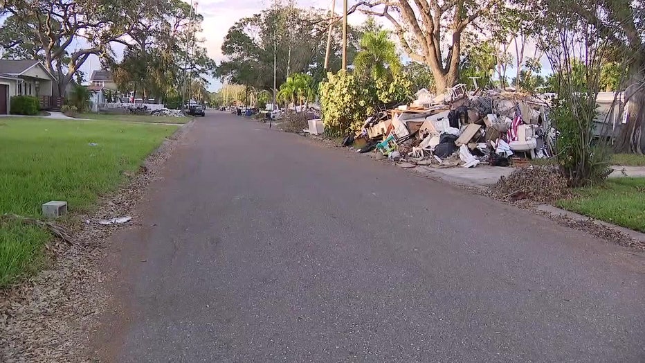 Hurricane-related debris on sides of Bay Area street.