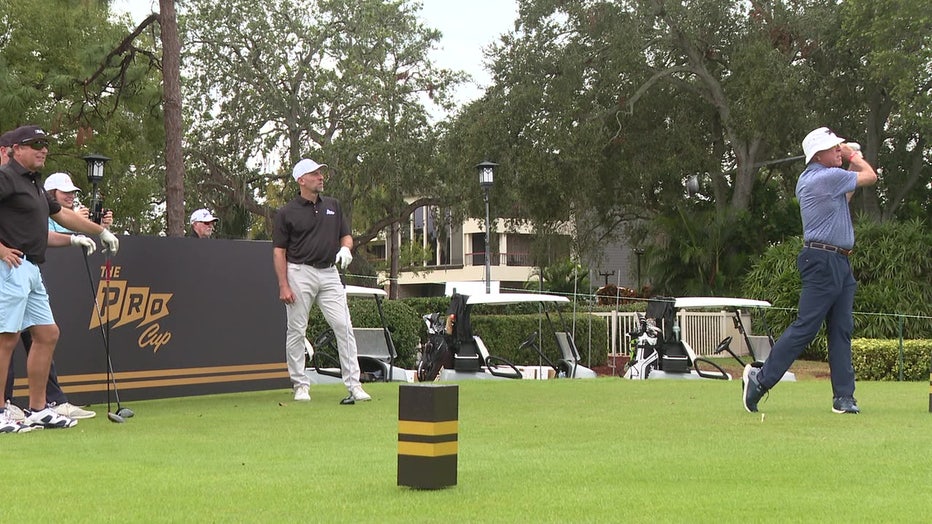 Kevin Millar, John Smoltz, and others stand around a tee box at Copperhead Golf Course during a practice round of golf.