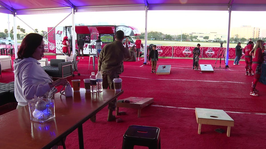 Father and son play cornhole at Buccaneers Winter Fest event.