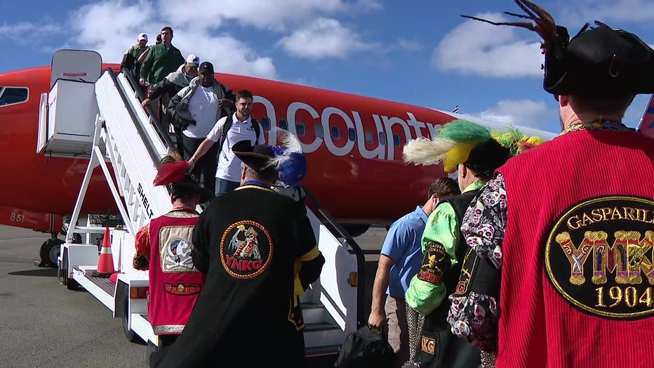 Gasparilla pirates greet college football players as they get off a plane in Tampa ahead of Gasparilla Bowl at Raymond James Stadium.