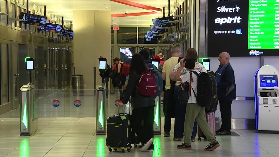 File: Travelers at Tampa International Airport