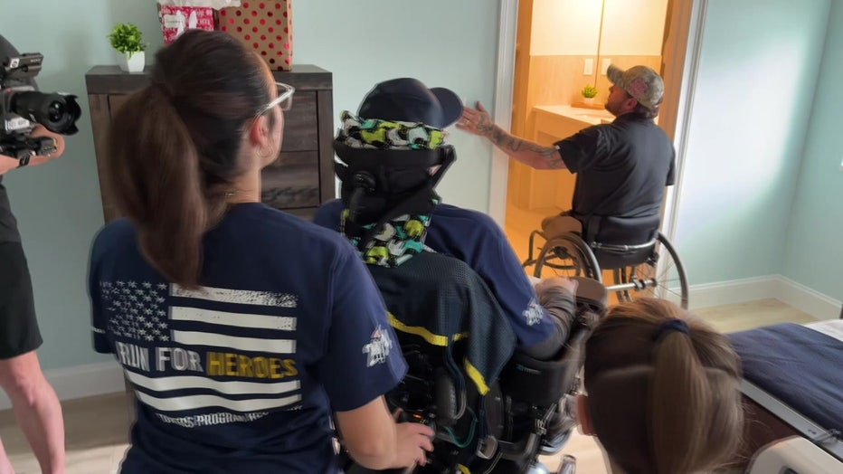 Rodriguez is shown a bedroom and bathroom in his new ADA-accessible house built by Tunnel to Towers.