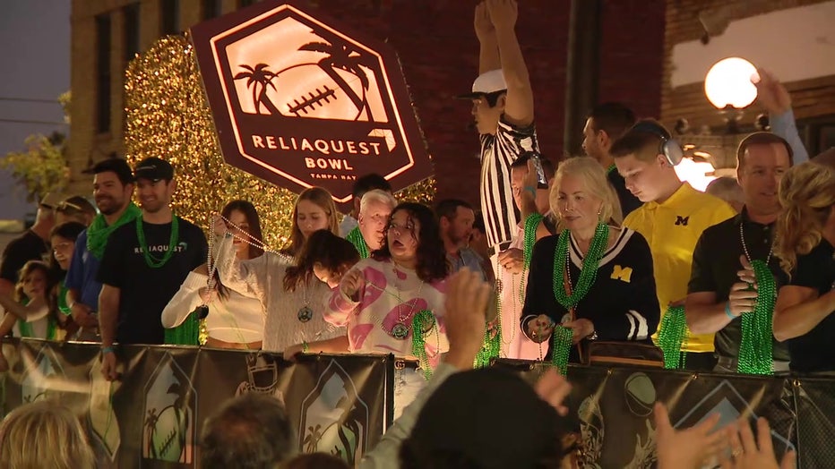 Patrons line the streets of Ybor City during the Reliaquest Bowl Parade.