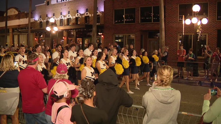 Michigan cheerleaders perform as part of Reliaquest Bowl Parade.