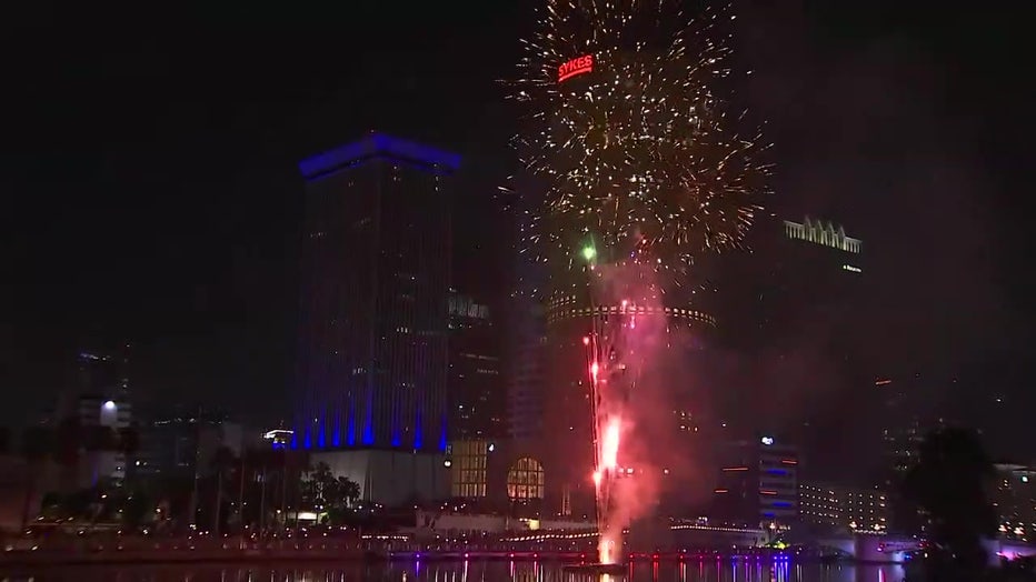 Fireworks being lit from the Tampa Riverwalk.