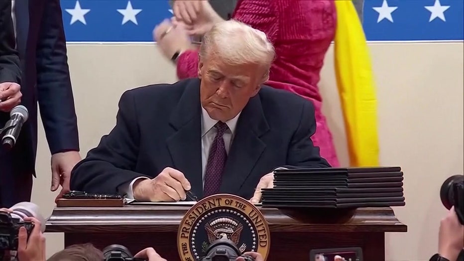 President Trump signing the