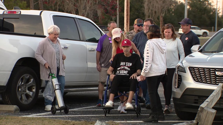 Steve and Amy Uhal surrounded by family and friends at Charlie's baseball game.