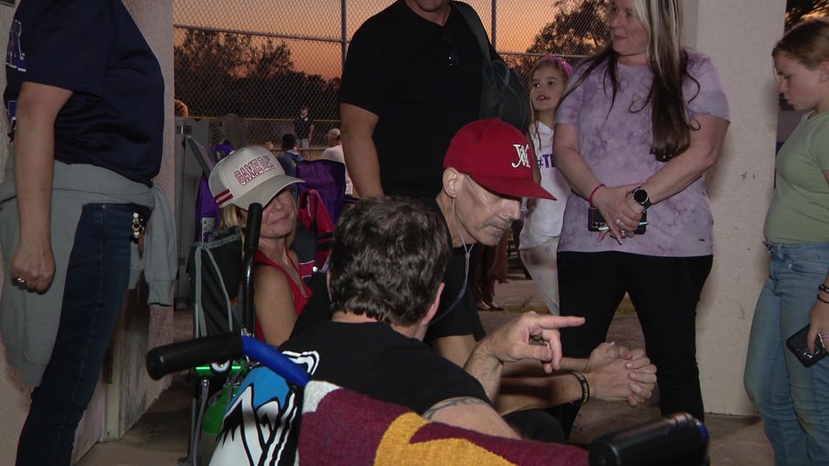 Steve and Amy Uhal watching Charlie play baseball.