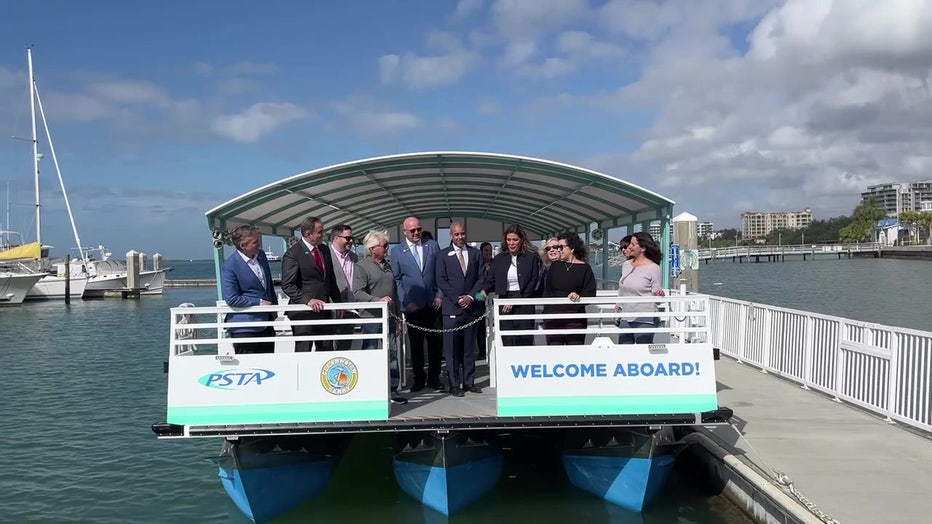 Officials take photo on new photo to mark its opening.