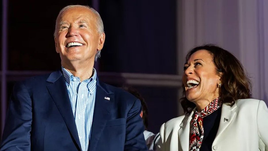 President Joe Biden and Vice President Kamala Harris laugh as they view the fireworks on the National Mall from the White House balcony during a 4th of July event on the South Lawn of the White House on July 4, 2024, in Washington, D.C. (Samuel Corum/Getty Images)