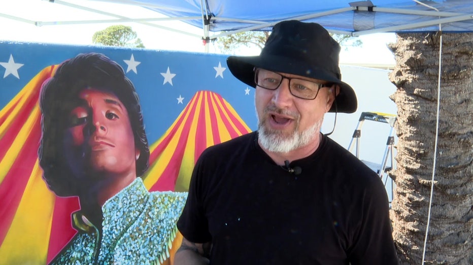 Sami Makela in front of his mural off of U.S. 41in Venice.