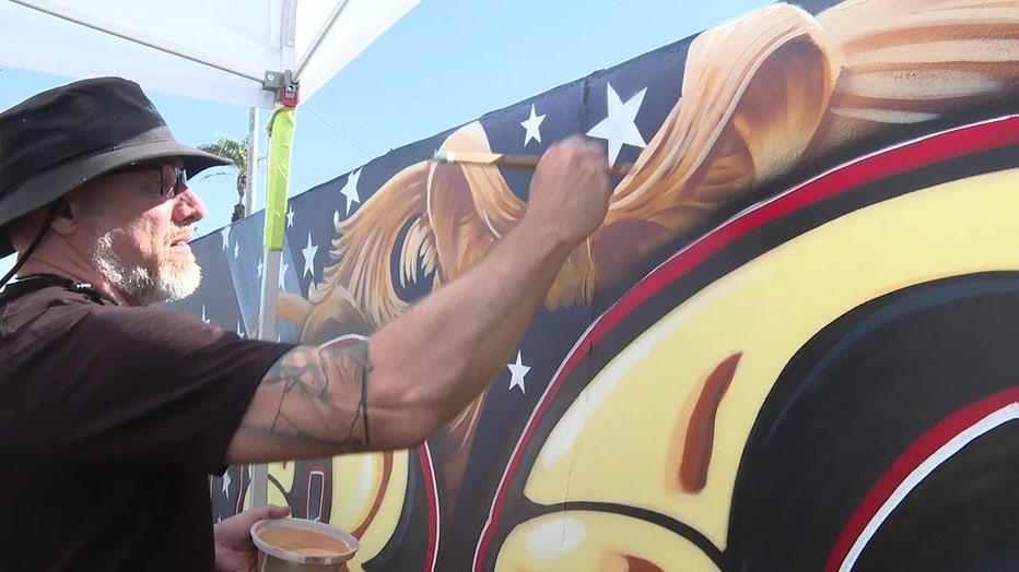 Sami Makela painting his mural off of U.S. 41in Venice.