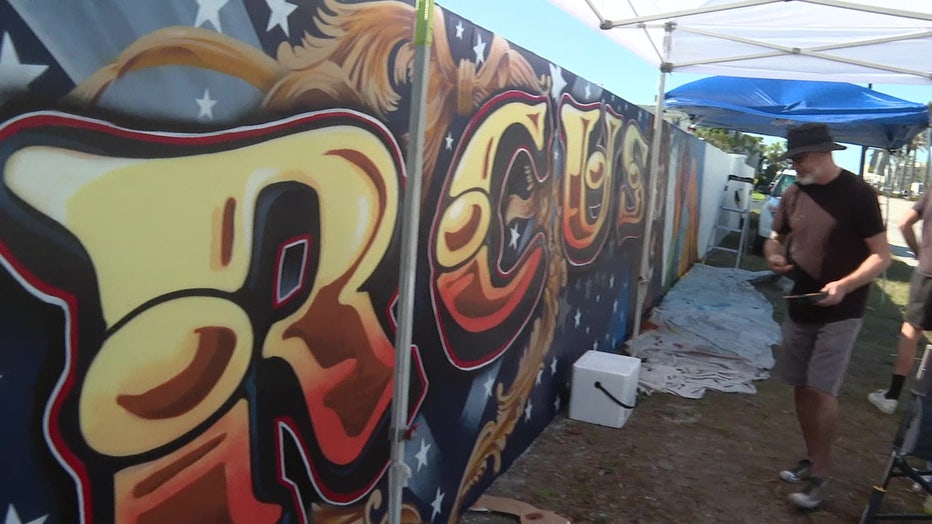 Sami Makela working on the mural outside of the Venice Municipal Mobile Home Park.