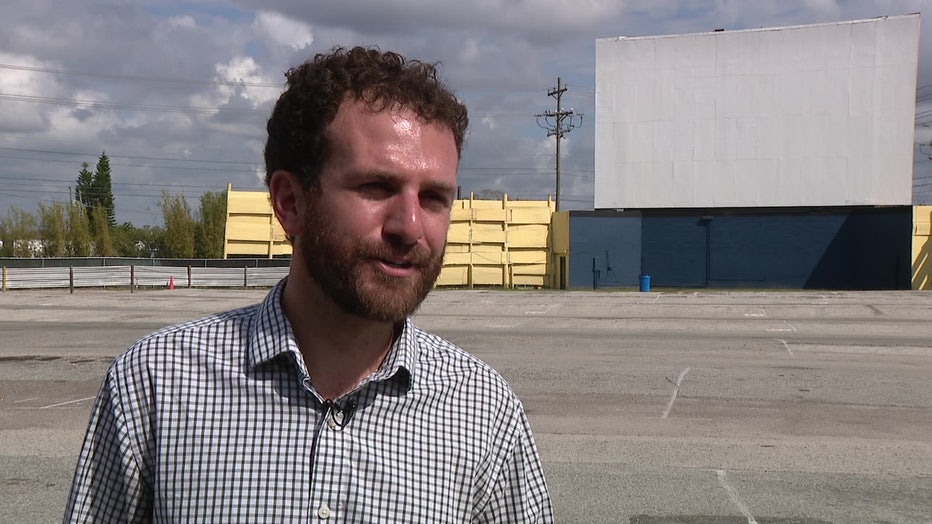 Chip Sawyer standing in front of Silver Moon Drive-In's big white showing screen.