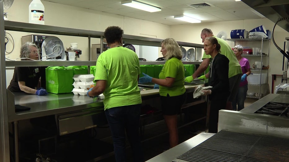 Viste volunteers preparing meals for elderly people.