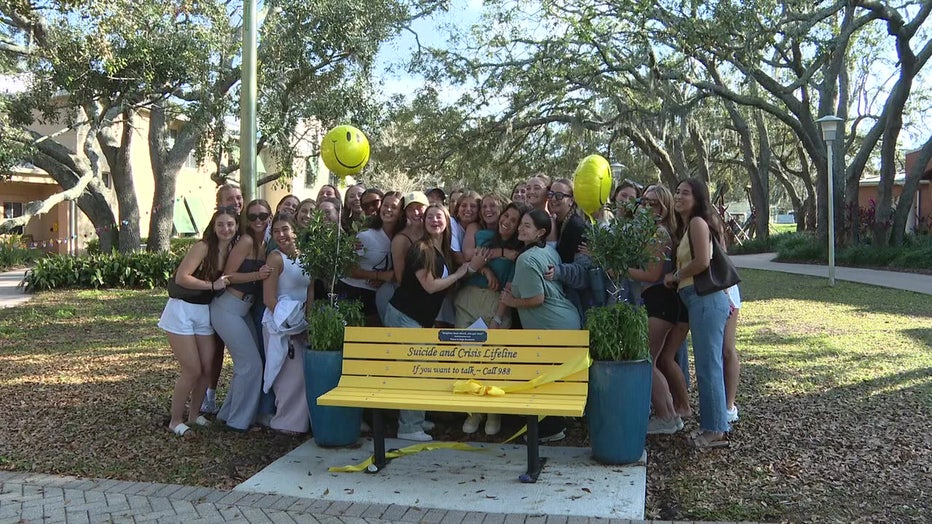 Crowd of supporters as Julia Pagán unveiled the 988 Suicide Prevention bench on USF's campus, which is meant to raise awareness about mental health resources.